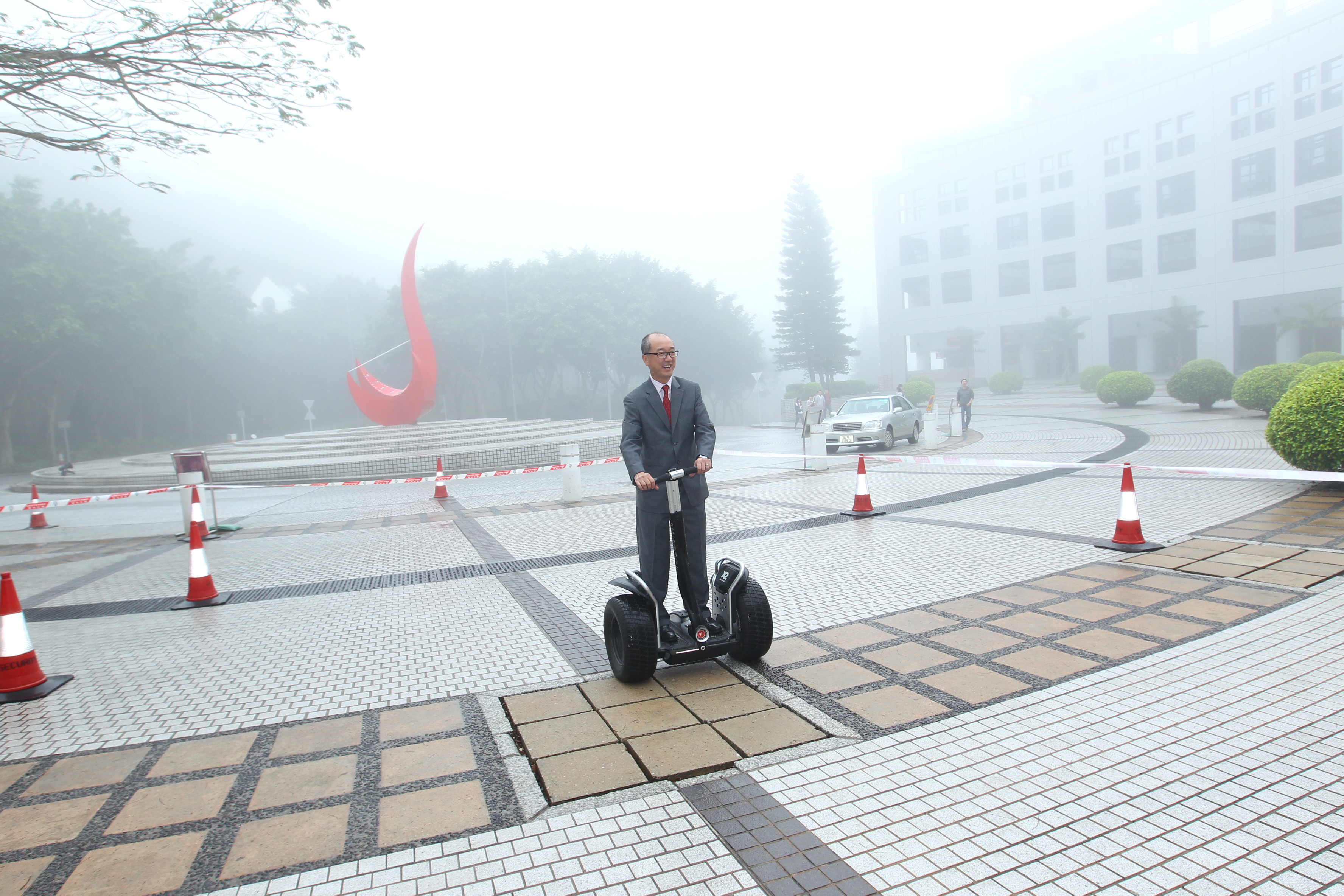  President Chan has a try on a light electric vehicle.